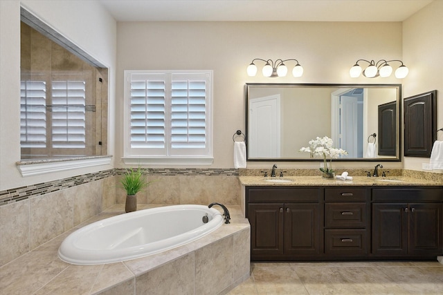 bathroom with double vanity, a sink, and a bath
