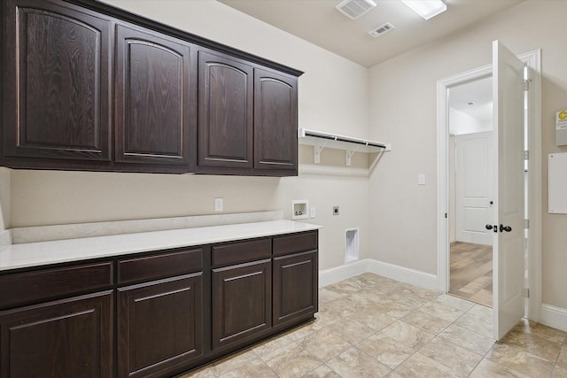 laundry area featuring cabinet space, hookup for a washing machine, electric dryer hookup, baseboards, and visible vents