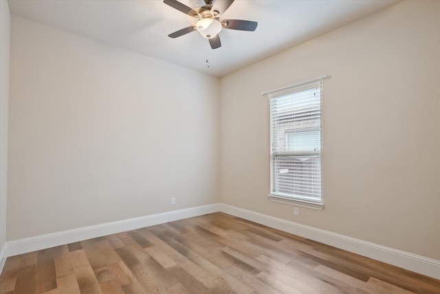 empty room with baseboards, ceiling fan, and light wood-style floors