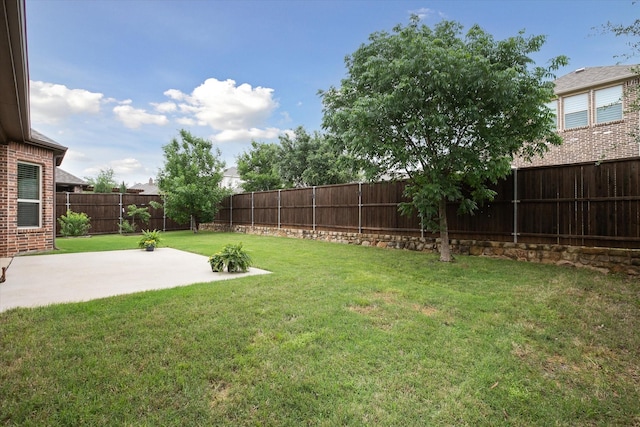 view of yard featuring a patio and a fenced backyard