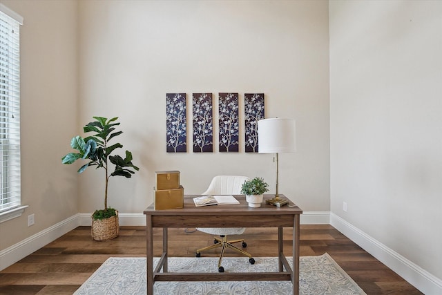 home office with baseboards and wood finished floors