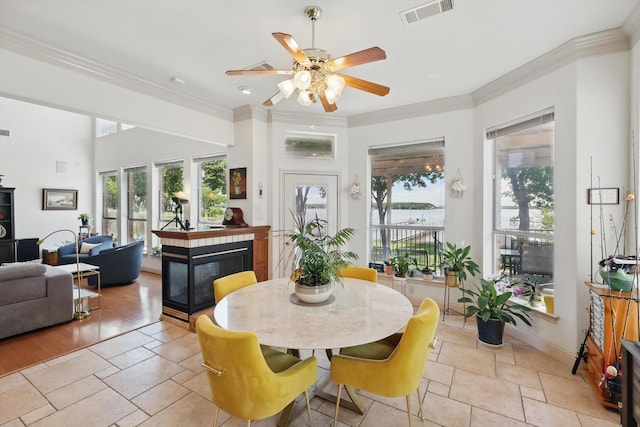 8913 Sunrise Point Ct, Fort Worth, TX 76135 - dining area with ornamental molding, a ceiling fan, stone tile floors, baseboards, and recessed lighting