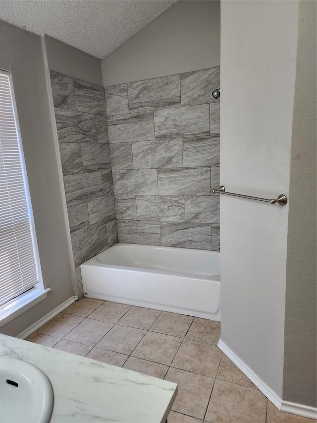 full bathroom featuring tile patterned flooring, baseboards, a textured ceiling, and shower / bath combination
