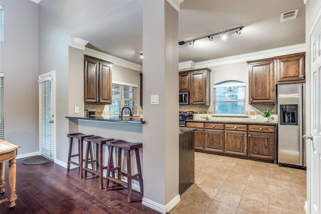 corridor featuring crown molding, arched walkways, french doors, and wood finished floors