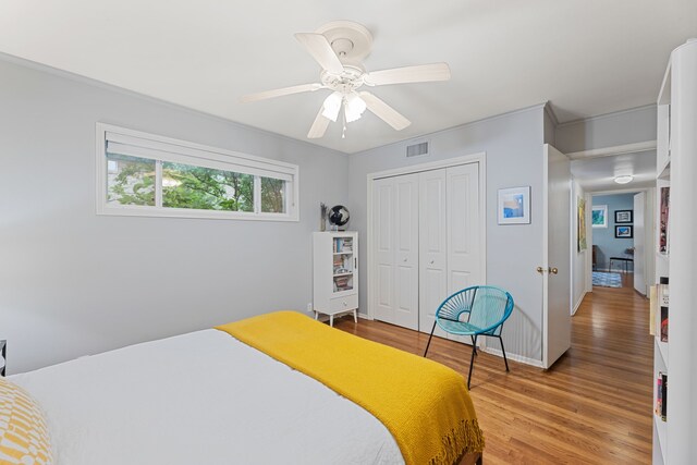 bedroom with visible vents, baseboards, a closet, and light wood-type flooring