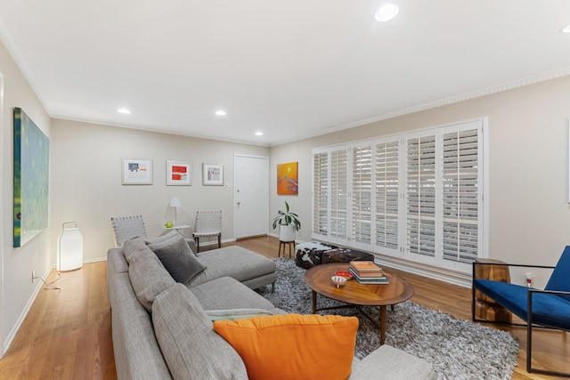living room with recessed lighting, ornamental molding, and wood finished floors