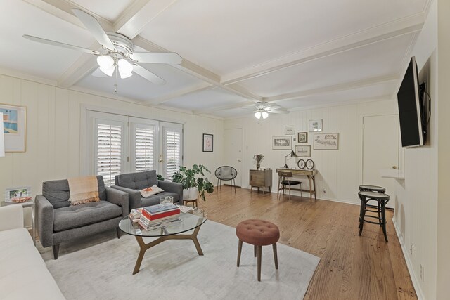 living room featuring light wood-type flooring, coffered ceiling, ceiling fan, and beam ceiling