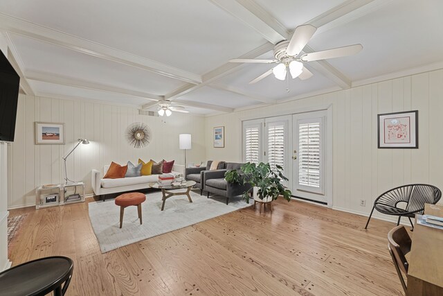 living area featuring ceiling fan, wood-type flooring, and beam ceiling