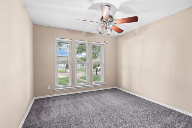 spare room featuring carpet floors, a ceiling fan, and baseboards