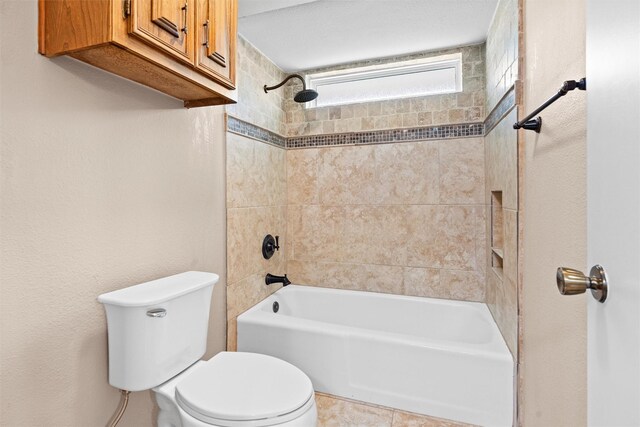 bathroom featuring shower / bathing tub combination and toilet