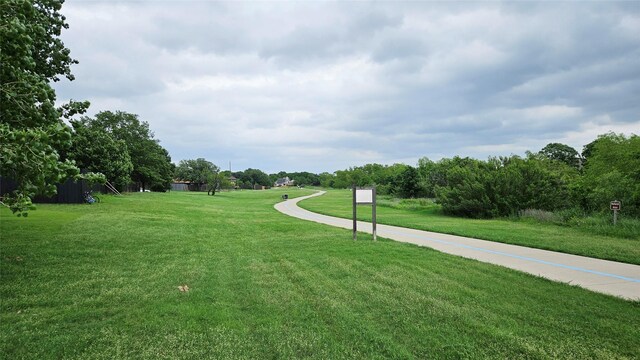 view of property's community featuring a yard