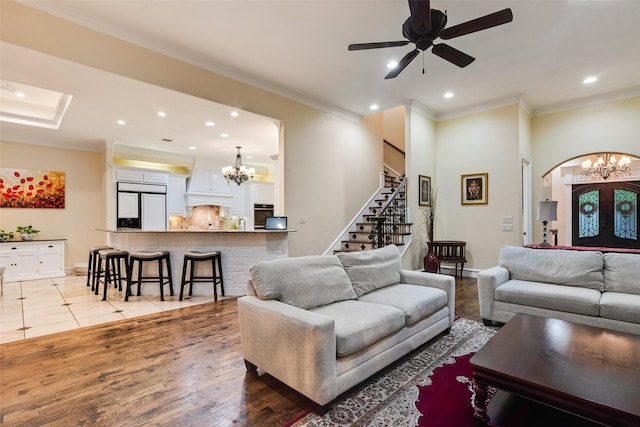 living room featuring recessed lighting, ornamental molding, stairs, and baseboards