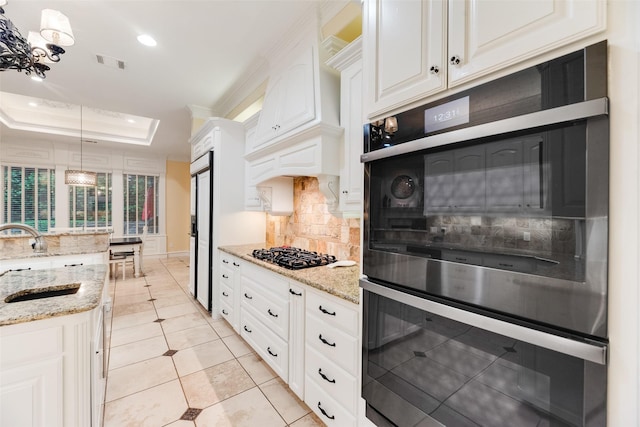 kitchen featuring black gas stovetop, a sink, double oven, backsplash, and visible vents