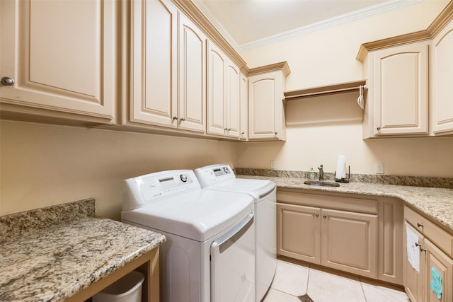 laundry room with cabinet space, washing machine and clothes dryer, a sink, light tile patterned floors, and ornamental molding