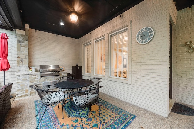 view of patio featuring an outdoor kitchen, outdoor dining space, and a grill