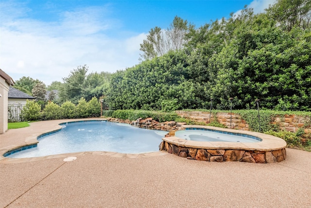 view of pool featuring a patio and a pool with connected hot tub