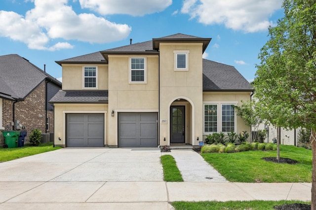 traditional-style house featuring a garage, a front lawn, roof with shingles, stucco siding, and concrete driveway