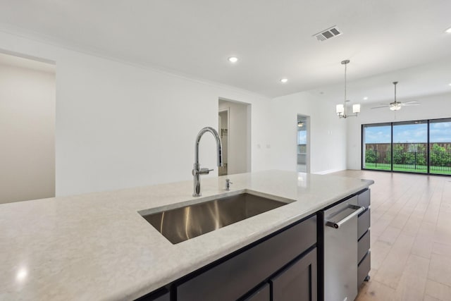 kitchen featuring decorative backsplash, appliances with stainless steel finishes, light wood-type flooring, a sink, and under cabinet range hood