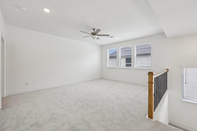 spare room featuring light carpet, a ceiling fan, and recessed lighting