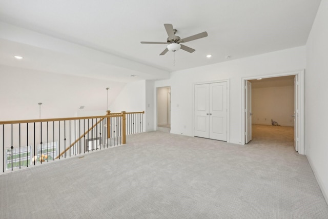 spare room featuring recessed lighting, a ceiling fan, and light carpet
