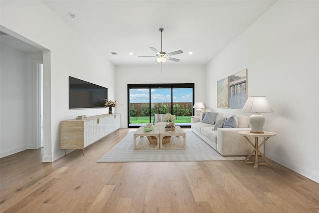 living room featuring a ceiling fan, visible vents, baseboards, recessed lighting, and light wood-style flooring