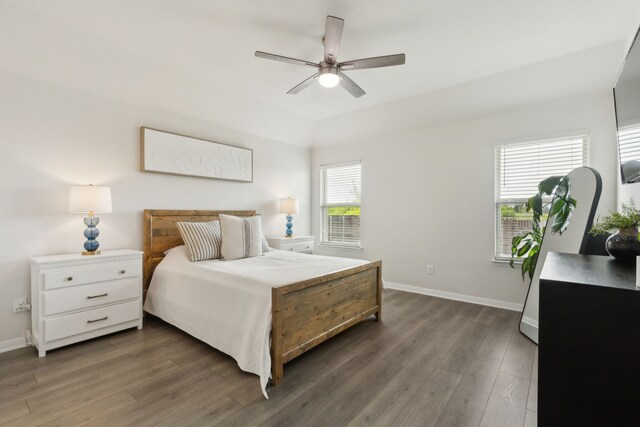 bedroom with dark wood-type flooring, baseboards, and ceiling fan