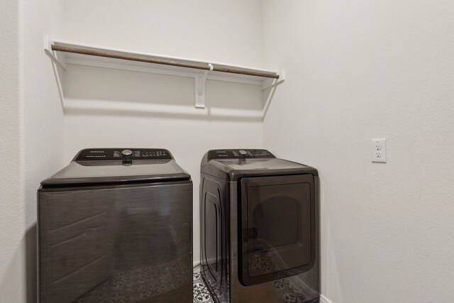 laundry area featuring separate washer and dryer and laundry area