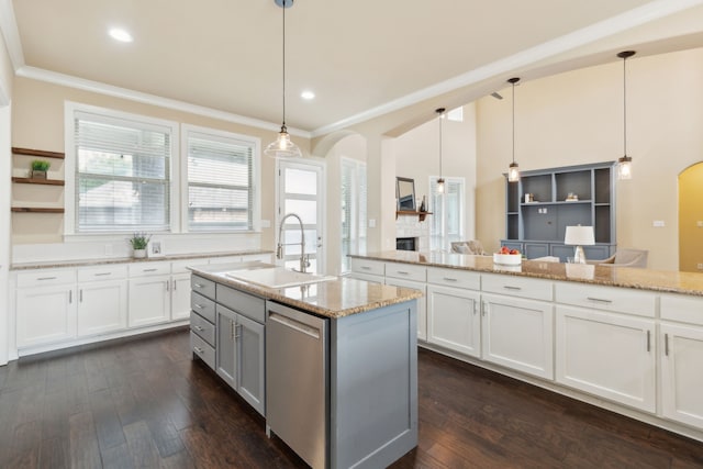 kitchen with arched walkways, a sink, dark wood-style floors, and a fireplace