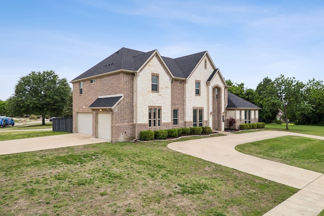 french country style house featuring a garage, stone siding, a front yard, and concrete driveway