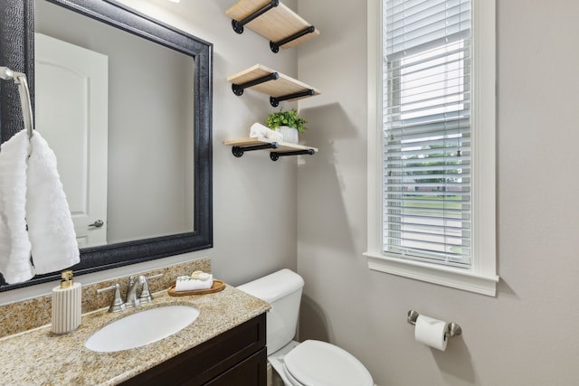 bathroom featuring toilet and vanity