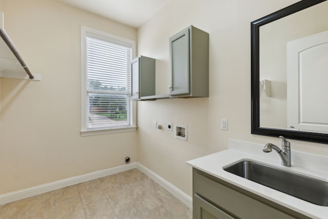 laundry room featuring washer hookup, electric dryer hookup, cabinet space, a sink, and baseboards