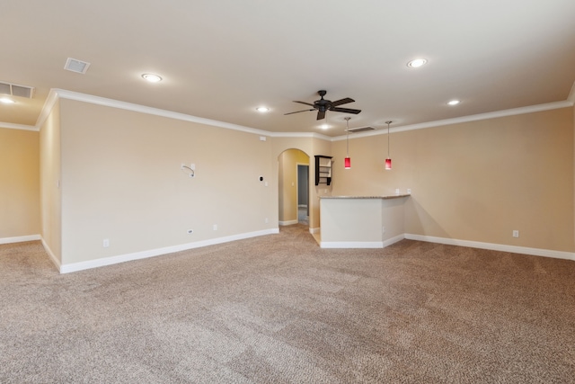 unfurnished living room with visible vents, ornamental molding, ceiling fan, recessed lighting, and arched walkways