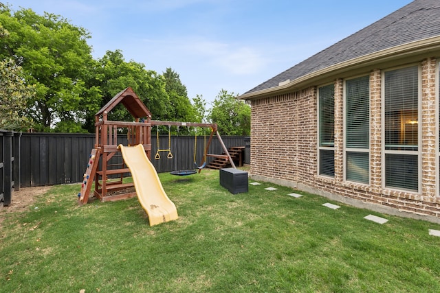 view of play area with a yard and a fenced backyard