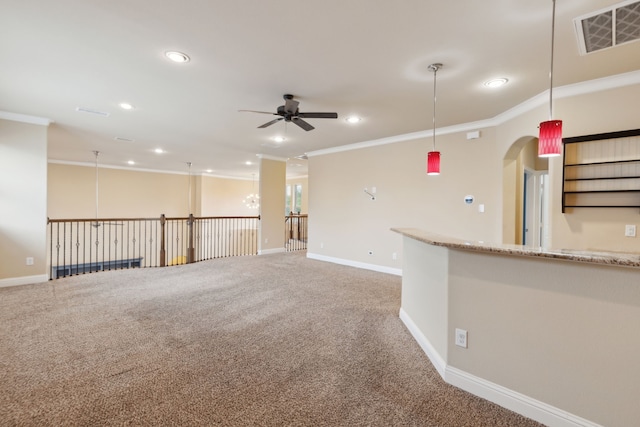 empty room with crown molding, ceiling fan, carpet floors, recessed lighting, and visible vents