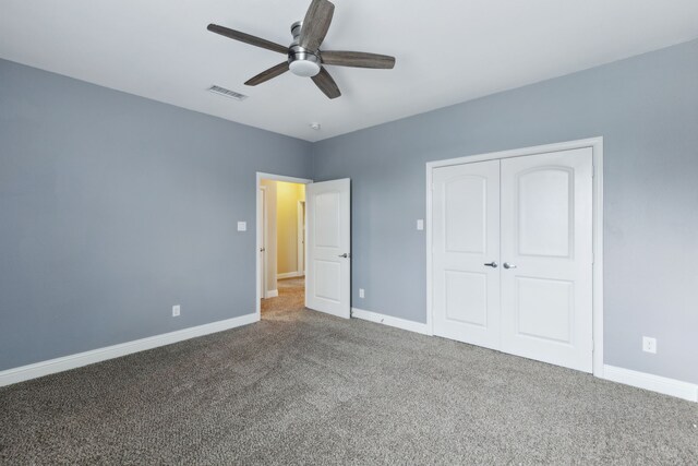 unfurnished bedroom featuring visible vents, carpet flooring, baseboards, and a closet