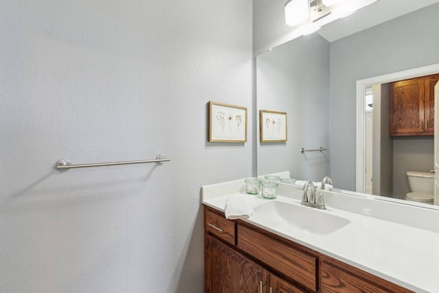 half bathroom with vanity and toilet