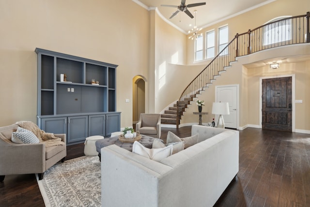 living area with crown molding, dark wood-style flooring, baseboards, and stairs