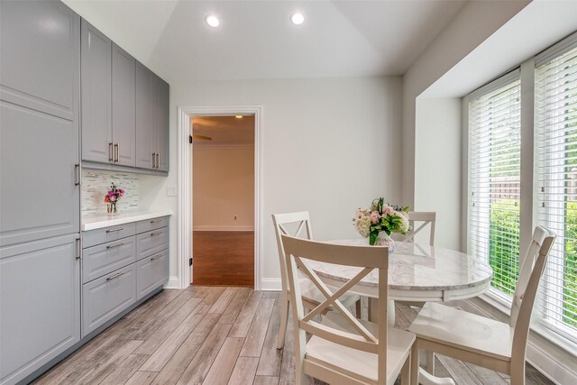 dining room featuring light wood-style floors, baseboards, and recessed lighting