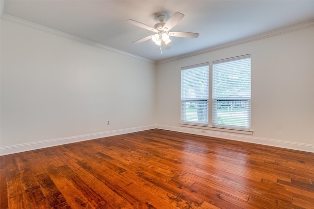 empty room featuring dark wood-type flooring, ornamental molding, baseboards, and ceiling fan
