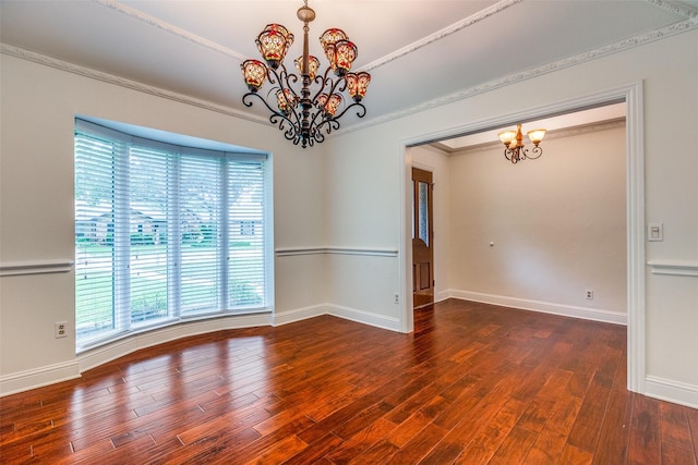 unfurnished room featuring baseboards, an inviting chandelier, ornamental molding, and wood finished floors