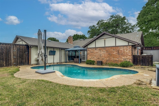 view of swimming pool with a fenced in pool, fence, a yard, and a patio area