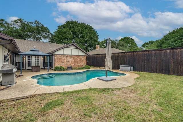 view of swimming pool featuring a lawn, a gazebo, a fenced in pool, a fenced backyard, and a patio