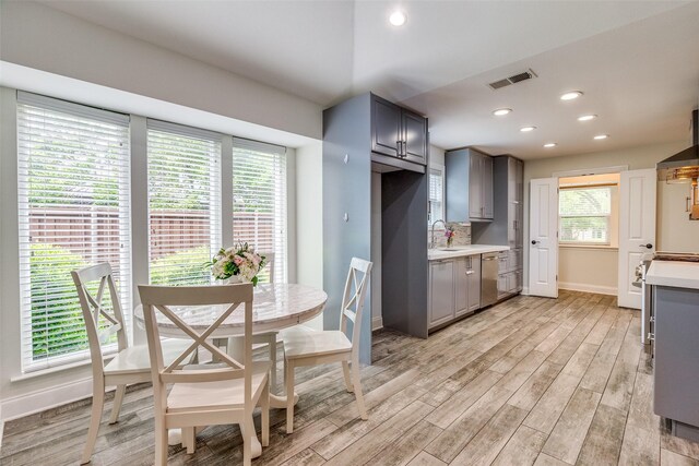 kitchen featuring light countertops, baseboards, visible vents, and light wood-style flooring