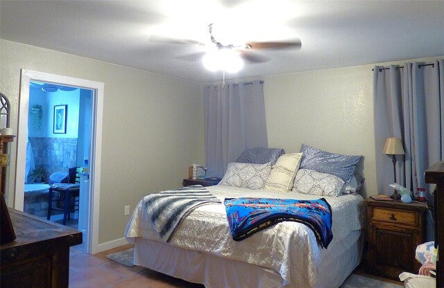 bedroom featuring tile patterned floors and ceiling fan