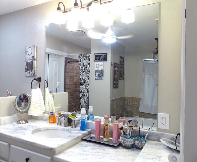 bathroom featuring a tub, a shower with curtain, visible vents, and vanity