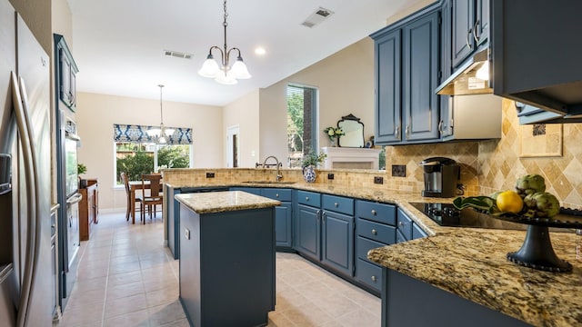 1230 Covina Ct, Allen, TX 75013 - kitchen featuring a chandelier, a sink, a peninsula, blue cabinets, and decorative backsplash