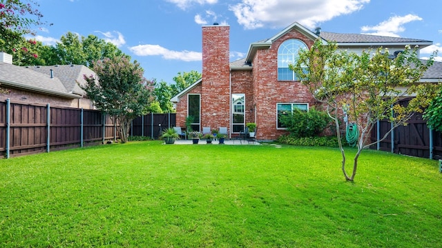 1230 Covina Ct, Allen, TX 75013 - rear view of property featuring a chimney, brick siding, and a patio