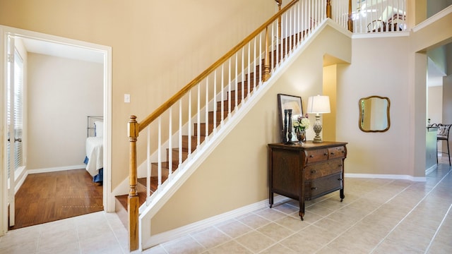1230 Covina Ct, Allen, TX 75013 - stairway featuring a towering ceiling, tile patterned floors, and baseboards