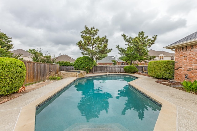 view of pool with a patio, a pool with connected hot tub, and a fenced backyard