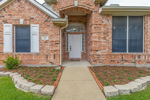 entrance to property with brick siding